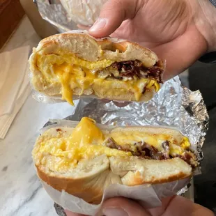 a hand holding a sandwich