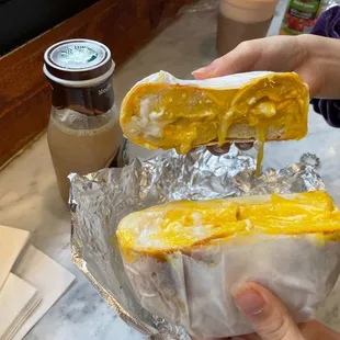 a person holding a sandwich
