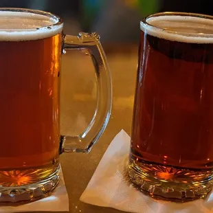 two mugs of beer on a table