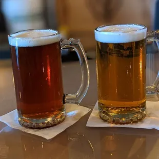 two mugs of beer on a table