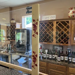 a woman looking at wine bottles