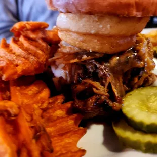 The Big Pig - pulled pork, barbecue sauce, jalapeno, melted cheddar, onion rings and coleslaw with pickles and your choice of side
