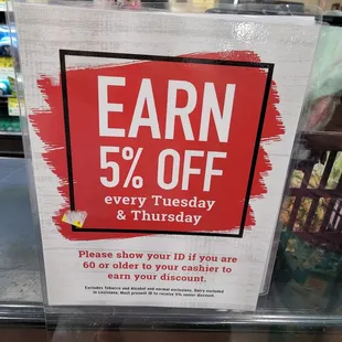 a sign that says earn 5 % off every tuesday
