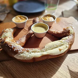 Pretzel with honey mustard and nacho cheese dipping sauces