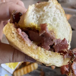 Pastrami sandwich with too much chemical tasting oil on the roll