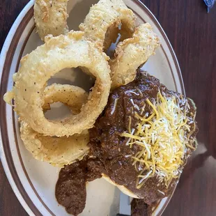 Open faced chili cheese burger and onion rings