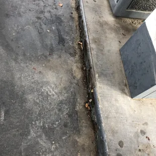 a corner of a sidewalk with a broken tv