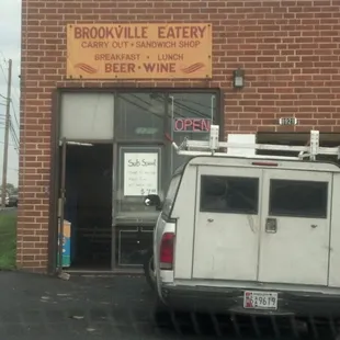 a van parked in front of a restaurant