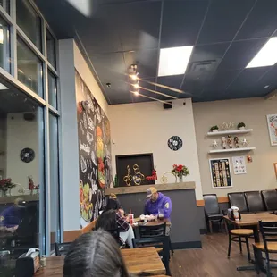 people sitting at tables in a restaurant