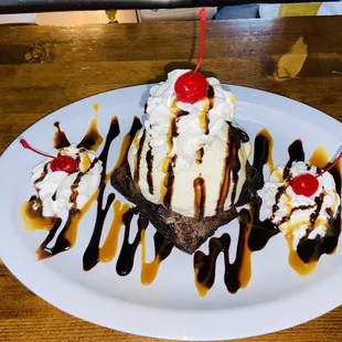 a chocolate sundae with whipped cream and a cherry on top