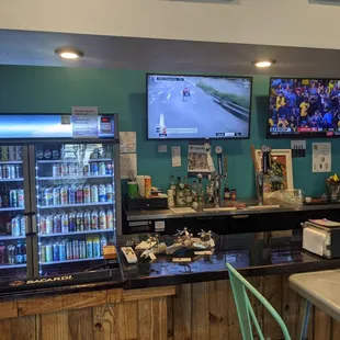Taps, beer cooler, and tvs in indoor dining area