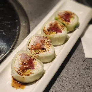 three sushi rolls on a plate