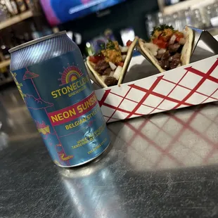 a can of soda and tacos