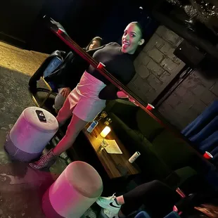 a woman leaning on a bar