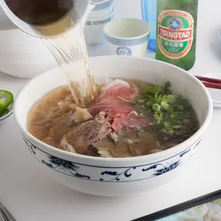 a bowl of soup with meat and vegetables