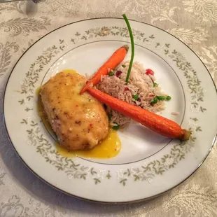 Chicken stuffed with brie craisans, apple,Orange butter sauce Jeweled rice and baby maple glazed carrots.
