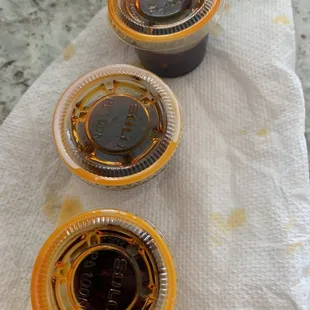 three cups of sauce on a napkin