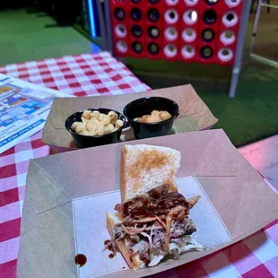 a pulled pork sandwich with macaroni and cheese