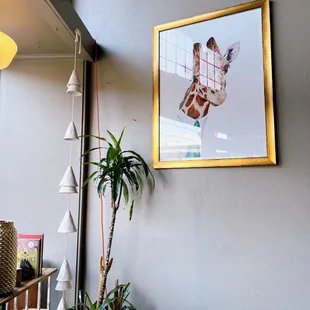 a picture of a giraffe hanging on the wall