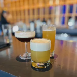 two glasses of beer on a bar