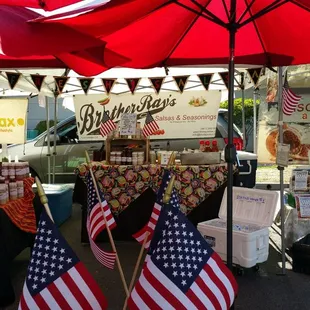 an outdoor market with american flags