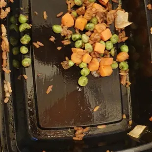 a black container filled with brussels sprouts and carrots