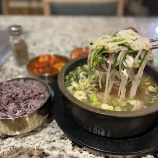 a bowl of noodles with meat and vegetables