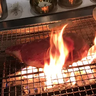 a steak being cooked on a grill