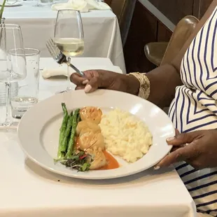 a woman holding a plate of food