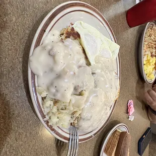 Eggs, home fries, biscuits &amp; gravy! Delicious   Was trying to match a Tee-jays barn yard buster from back home!