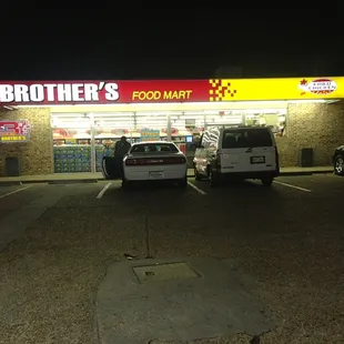 two cars parked in front of the store