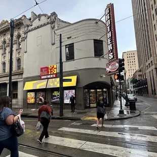 people crossing the street in the rain
