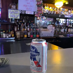 a can of beer on a bar counter