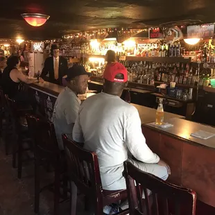 two men sitting at a bar