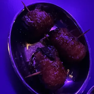 Bacon wrapped dates with queso Cabrales. Happy hour item