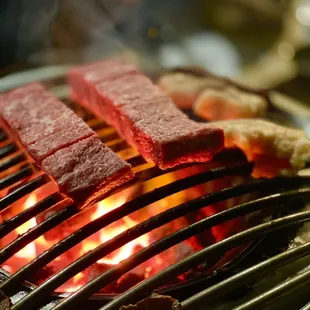steaks being cooked on a grill
