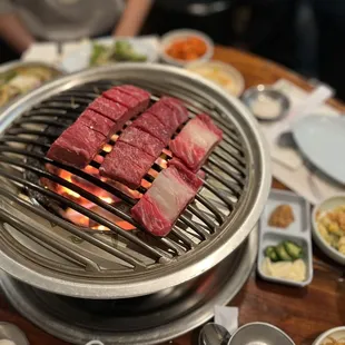 a grill with meat and vegetables on it