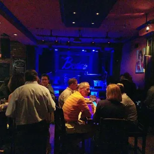 a group of people sitting at a bar