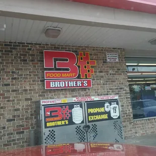 the outside of a restaurant with a brick wall
