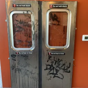 double doors with graffiti