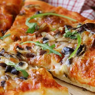 a sliced pizza on a cutting board