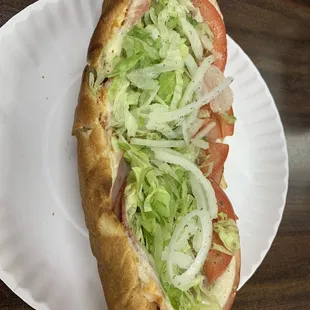 a large sandwich on a paper plate