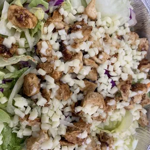 a bowl of salad with chicken and lettuce
