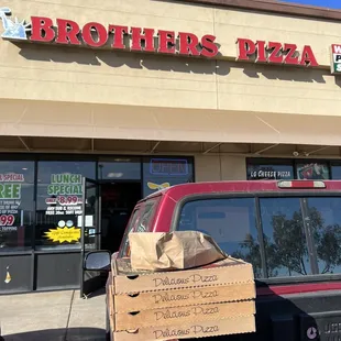 a truck with a pizza box in the bed