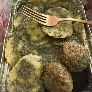 Pesto raviolis with meatballs. The pesto is great, the meatballs are fantastic, but the raviolis have a flavorless, mushy filling.