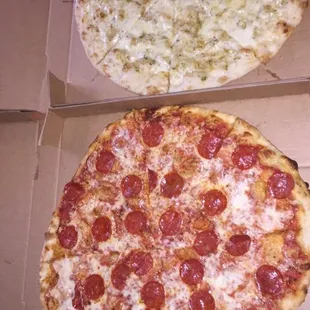 two pepperoni pizzas in a box