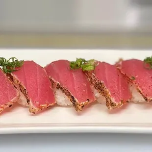 a close up of a plate of sushi rolls