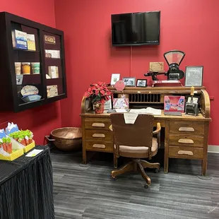 a desk with a chair and a television