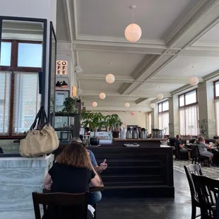 people sitting at tables in a restaurant