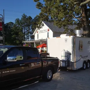 a black truck and a white trailer